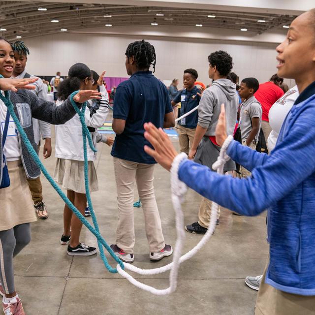 2019 Event attendees smiling and playing with ropes