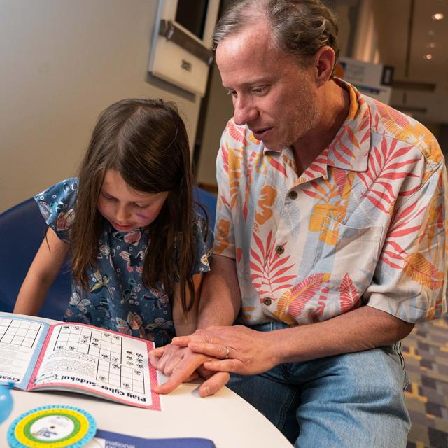 Girl and Man working on sudoku puzzle at 2019 Festival