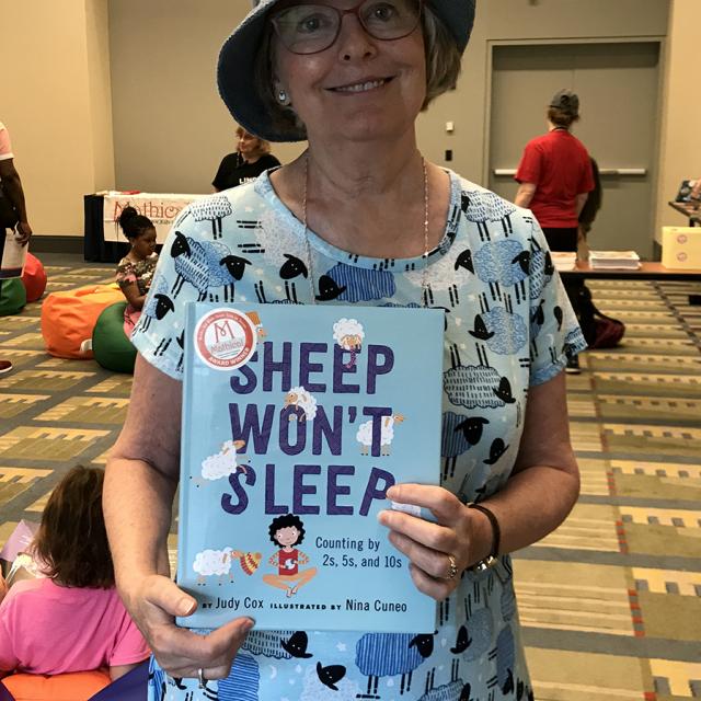 Mathical Author Judy Cox holding book - Sheep Won't Sleep - National Math Festival 2019