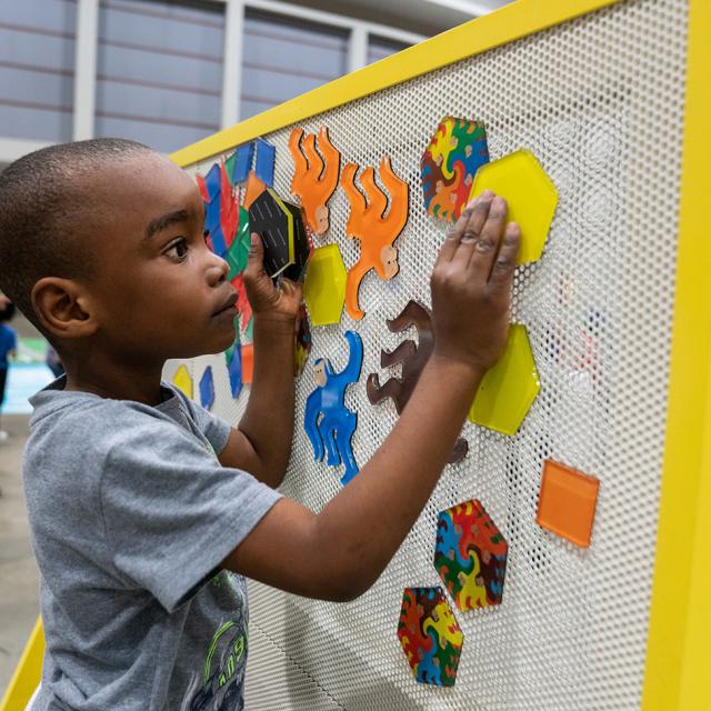 Boy playing with colorful blocks at 2019 Festival