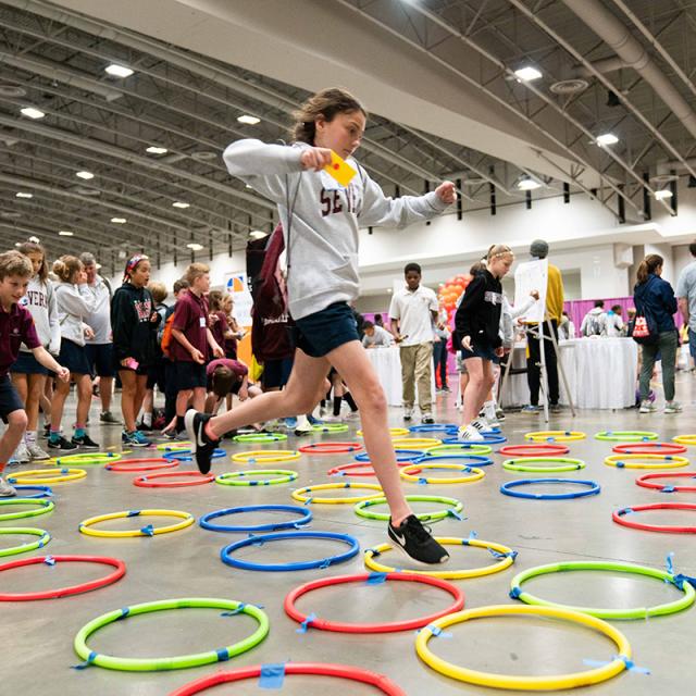 Girl jumping in hoops on the floor at 2019 Festival