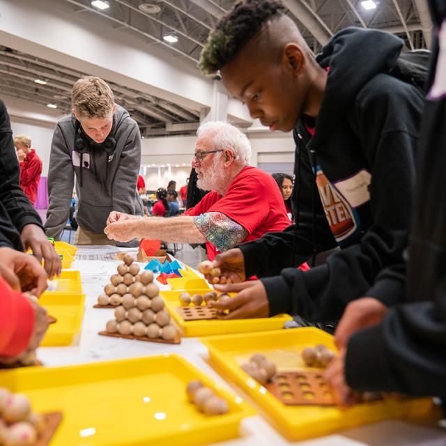 boy working with wood blocks at National Math Festival 2019